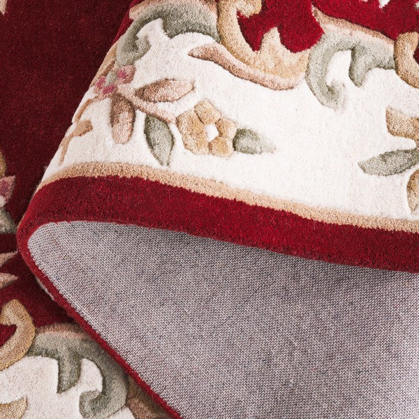 Close-up of Aurelia dark red hand tufted New Zealand wool rug showing plush thickness and texture