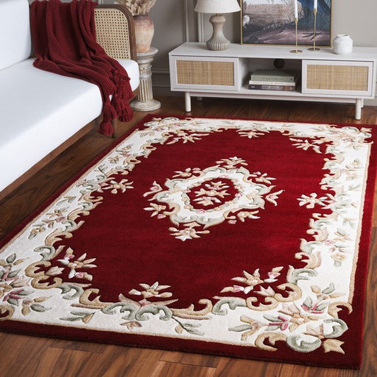 Aurelia dark red traditional floral medallion hand tufted wool rug in a living room